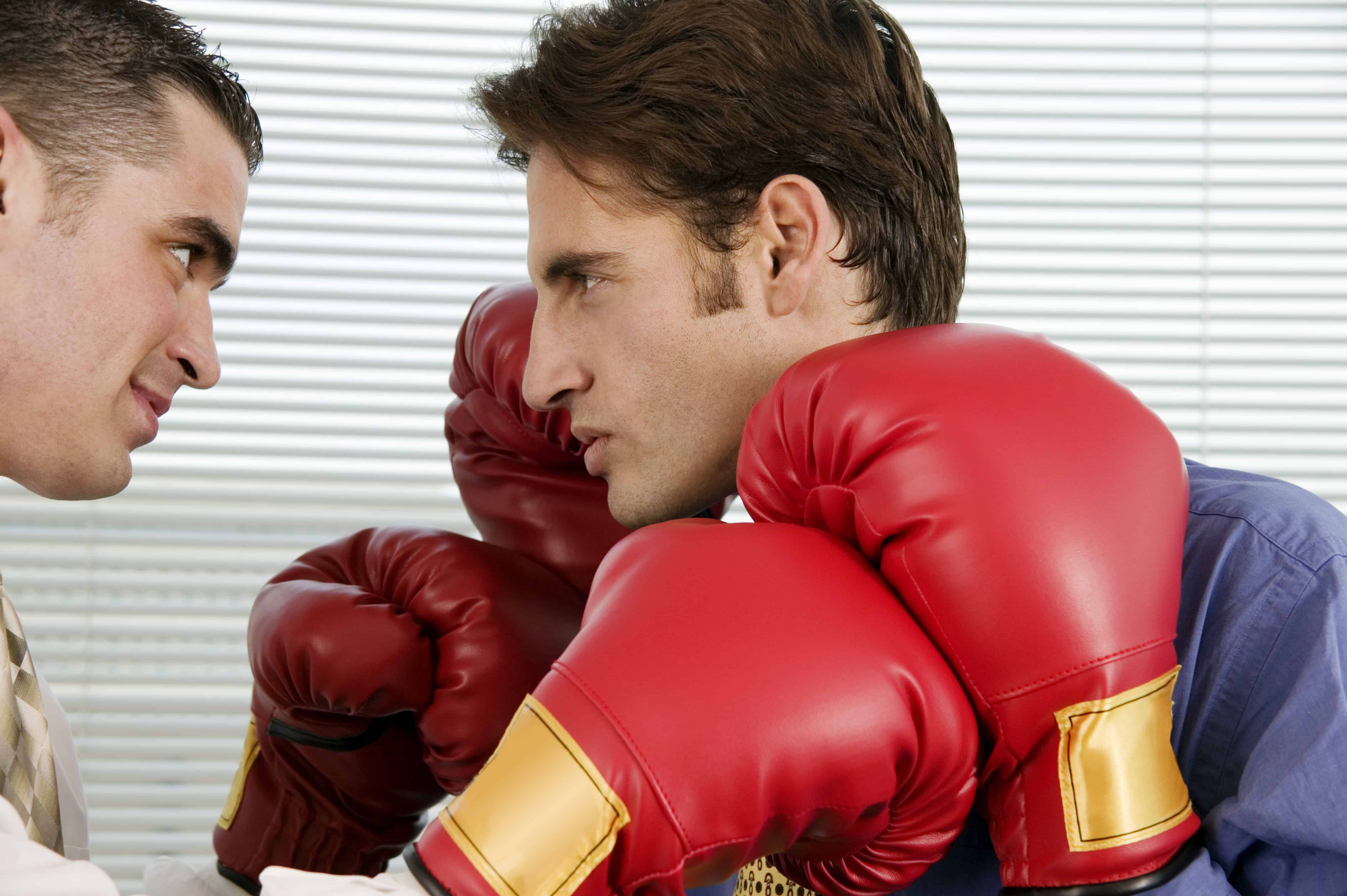 Getting even in the workplace two men with boxing gloves