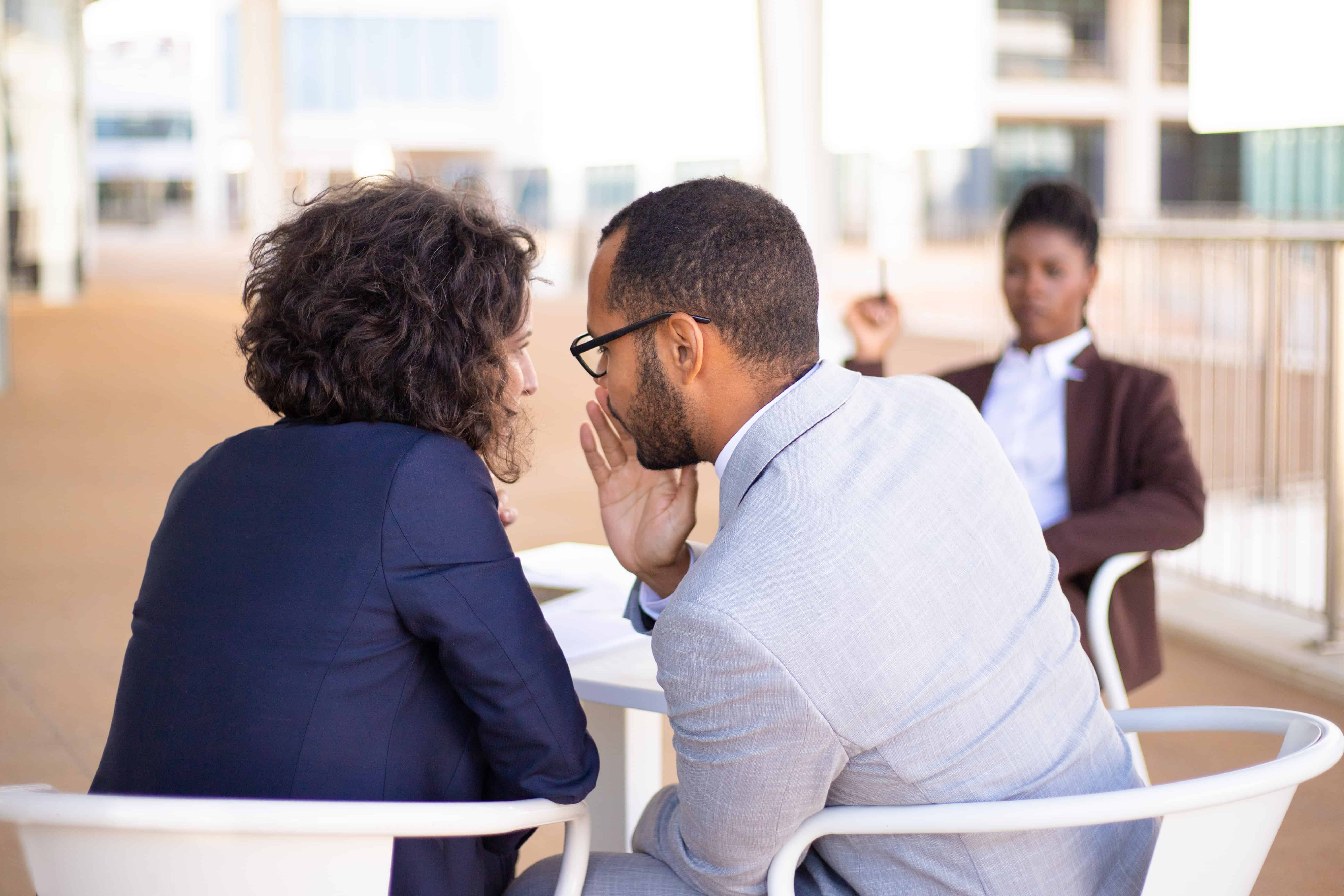 employees-gossiping-about-colleague-in-toxic-work-environment